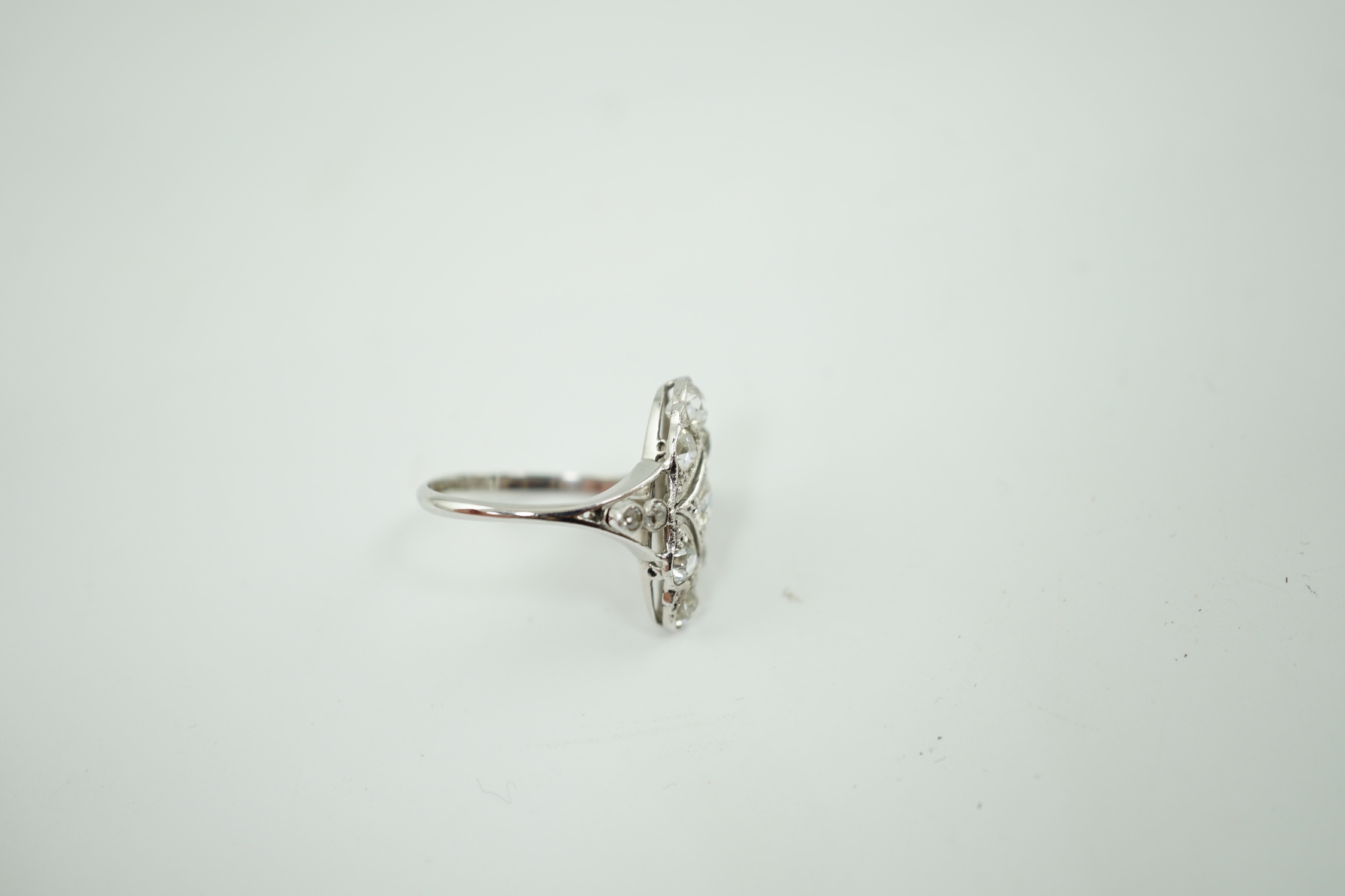 An early 20th century 18ct white gold, platinum and millegrain set old cut diamond cluster ring